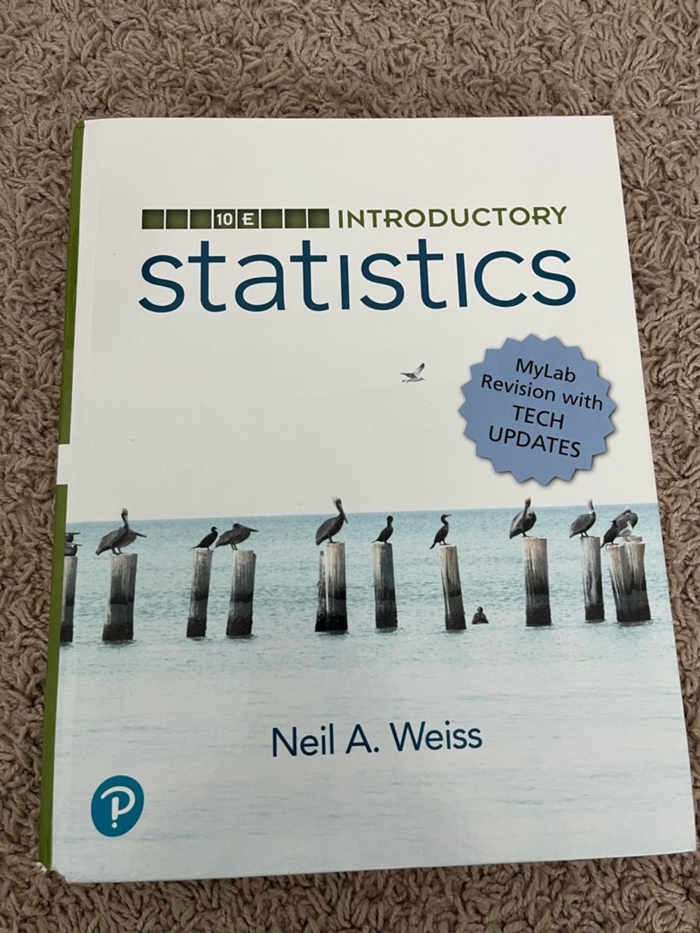 Pearson Introductory Statistics Textbook in White, Blue, Green